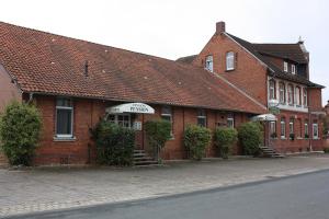a red brick building with a store on a street at Agardy,s Landgasthof in Holle