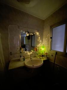 a bathroom with a sink and a mirror at Cozy Private Room with Jacuzzi Maadi in Cairo