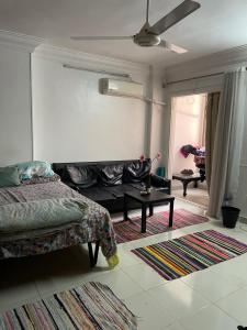 a bedroom with a bed and a living room at Cozy Private Room with Jacuzzi Maadi in Cairo