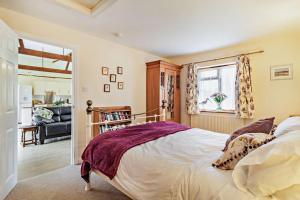 a bedroom with a bed and a living room at 1 Bed in St. James South Elmham Halesworth oc-t27361 in Saint James