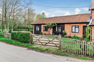 a house with a wooden fence in front of it at 1 Bed in St. James South Elmham Halesworth oc-t27361 in Saint James