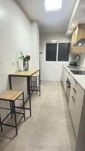 a kitchen with a table and two chairs in it at Puerta del Mar 2 in Adra +6 photos