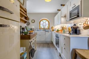 a kitchen with white cabinets and a window at 2 Bed in Tunstead oc-o32203 in Tunstead