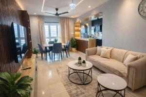 a living room with a couch and a table at Sylevo 2bhk Baner in Pune