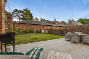 a patio with chairs and a grill in a yard at 2 Bed in Tunstead oc-o32203 in Tunstead