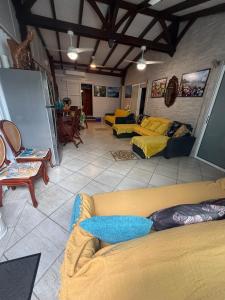 a living room with couches and chairs in a room at residence caramboles in Fort-de-France