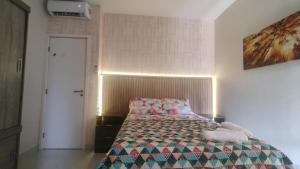 a bedroom with a bed with a quilt on it at Casa Mobiliada - Praia Imbassaí in Imbassai +17 photos