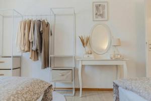 a bedroom with a dressing table and a mirror at Dreiländer-Blick Apartment 2 Schlafzimmer in Lörrach