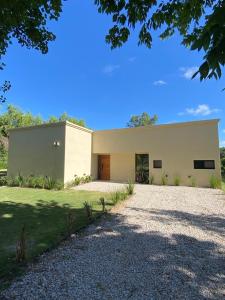 a large white house with a driveway at La Antonieta in Brandsen