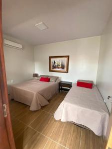 a room with two beds in a room at Chácara Julião da usina in Juazeiro do Norte +9 photos