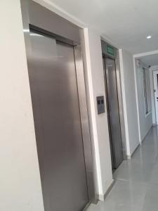a hallway with two elevators in a building at Monoambiente zona UNNE in Resistencia