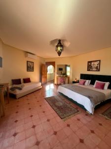 a large bedroom with a large bed and a couch at Private pool villa & garden Marrakech in Marrakesh +86 photos