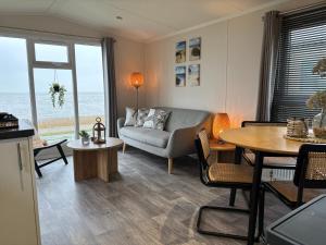 a living room with a couch and a table at Noa aan Zee in Westerland