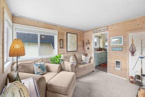 a living room with a couch and a table at Coho Cottage in Rockaway Beach