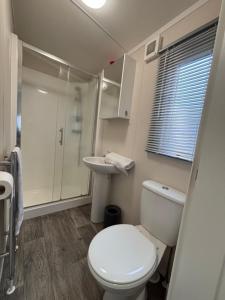 a bathroom with a toilet and a sink at Noa aan Zee in Westerland +41 photos