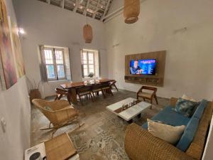 a living room with a blue couch and a table at Casa Payis Hotel in Cartagena de Indias