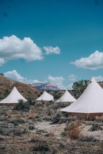 a group of white tents in the desert at Bryce Canyon Escalante Glamping in Cannonville