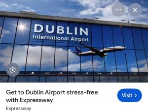 an airplane is reflecting in the windows of a building at Private en-suite studio in Dunboyne