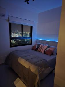 a bedroom with a large bed with a large window at Emilie Home in Sao Jose do Rio Preto +7 photos