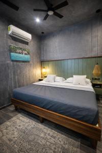 a bedroom with a large bed in a room at Kasa Nikte in Tulum