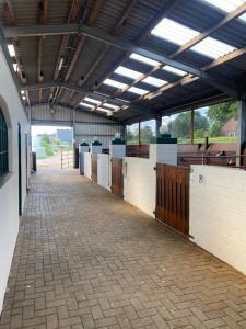a building with a hallway with stalls in it at Hof Eichendiek Time Out Village- Haus Naturruhe in Blekendorf
