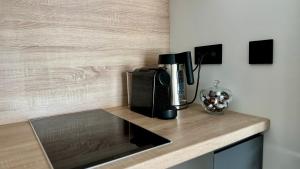 a kitchen counter with a coffeemaker on a counter top at Casa Nostra in Białystok