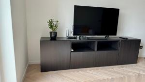 a entertainment center with a television on top of it at Casa Nostra in Białystok