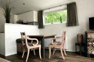 a dining room with a table and two chairs at Hof Eichendiek Time Out Village- Haus Naturruhe in Blekendorf
