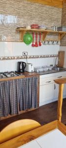 a kitchen with a sink and a stove top oven at Cabaña Vicente del Mar in Isla Negra +1 photo