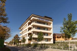 a white building with a sign on the side of it at Crystal Luxury in Craiova