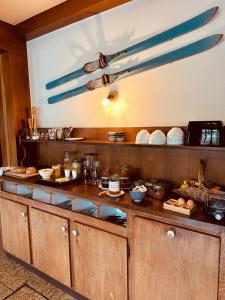 a kitchen with a counter with food on it at Auberge La Cléa in La Pesse