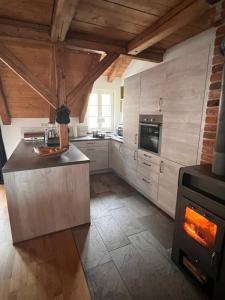 a kitchen with a stove in the middle of it at Ferienwohnung Hansnhof in Wilhelmsthal +6 photos