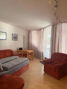 a living room with a couch and a table at Siebert Apartment in Titisee-Neustadt