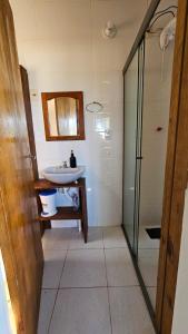 a bathroom with a sink and a shower at Casa ceu in Florianópolis