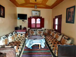 a living room with couches and a table at Guest house wakrim in Tafraout +26 photos