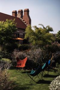 two chairs sitting in the grass in front of a house at Jonojé Luxury Suites in Bruges +79 photos