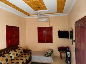a living room with a couch and a tv at Guest house wakrim in Tafraout