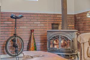 a brick fireplace with a bike parked next to it at Khan River Cabin in Great Cacapon