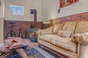 a living room with a couch and a fireplace at Khan River Cabin in Great Cacapon