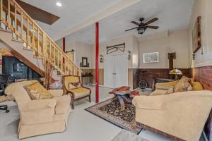 a living room with two couches and a fireplace at Khan River Cabin in Great Cacapon