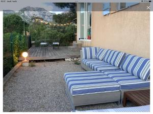 a couch sitting on the side of a house at La Panouse in Marseille