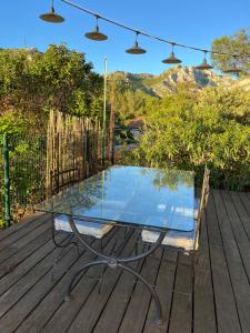 a glass table sitting on a wooden deck at La Panouse in Marseille +10 photos