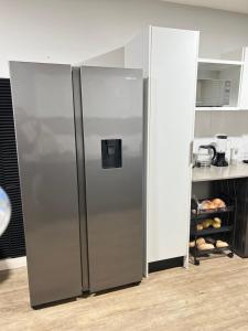 a stainless steel refrigerator in a kitchen at Luxury Property in Kingsborough