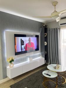 a living room with a flat screen tv on a wall at Luxury Property in Kingsborough