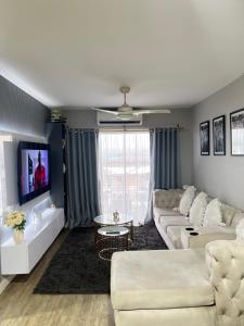 a living room with a couch and a table at Luxury Property in Kingsborough