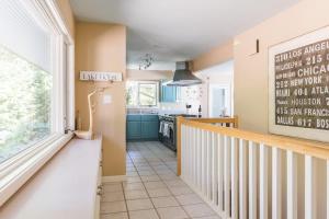 a kitchen with a staircase leading into a kitchen with a sink at The Great Escape Blocks From Your Private Beach in New Buffalo