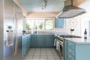 a kitchen with blue cabinets and a sink at The Great Escape Blocks From Your Private Beach in New Buffalo +23 photos