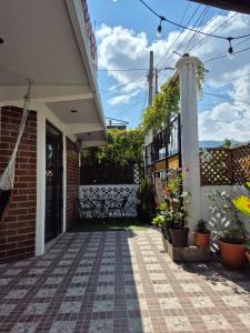 a porch of a house with a bench and plants at Home Garden in San Pedro La Laguna