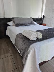 a bedroom with two beds with towels on them at Home Garden in San Pedro La Laguna