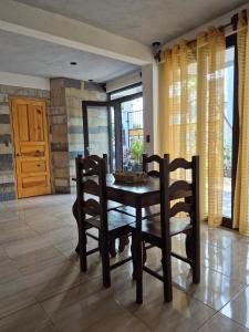 a dining room with a table and two chairs at Home Garden in San Pedro La Laguna